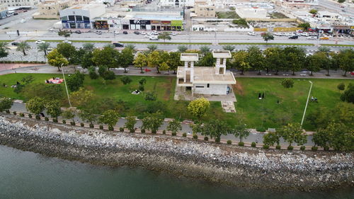 High angle view of buildings and trees in city