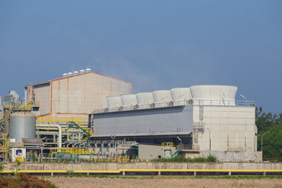 Low angle view of factory against blue sky