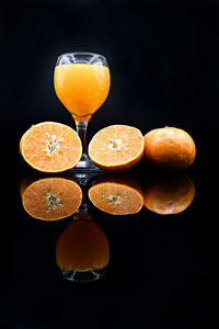 Close-up of orange juice against black background