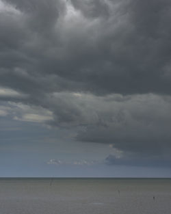 Scenic view of sea against storm clouds