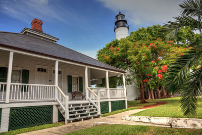 Key west lighthouse with a poinciana tree out front overlooks old town key west in monroe county