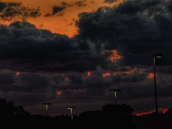 Silhouette trees against sky at sunset