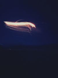 Light trails against clear sky at night