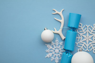 Directly above shot of christmas decorations on blue background