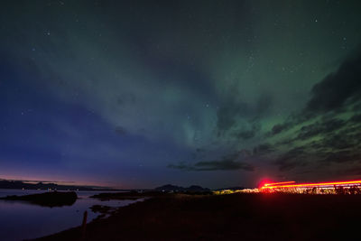 Scenic view of illuminated mountains against sky at night
