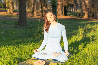 Young woman sitting on field