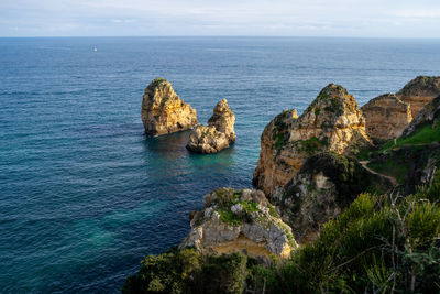 Rocks in sea against sky