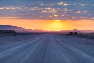 Scenic view of desert against sky during sunset