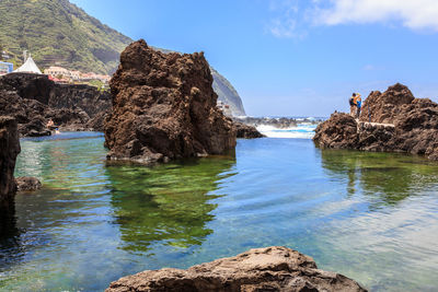  rock formation in a pool against the sky