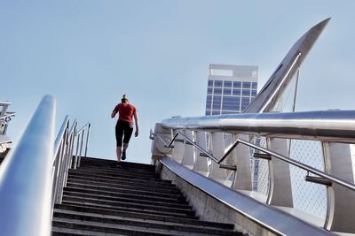 Rear view of woman walking on staircase