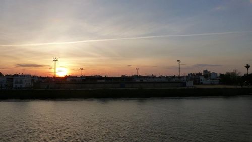 Scenic view of river against sky at sunset