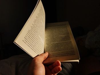 Close-up of person holding book