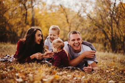 Full length of father and daughter in park during autumn