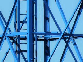 Low angle view of bridge against blue sky