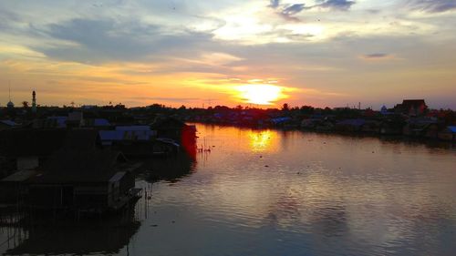 Reflection of buildings in water at sunset