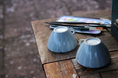 High angle view of old cups on table