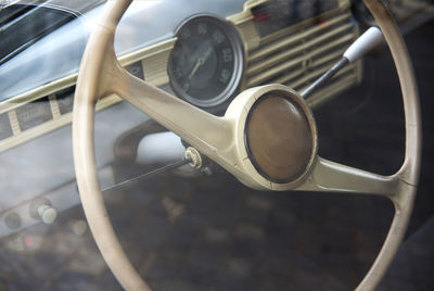 Filtered photo of a vintage car steering wheel and dashboard