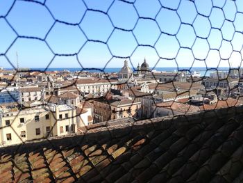 Buildings in city against blue sky