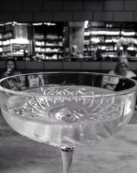 Close-up of hand holding wine glass on table at restaurant