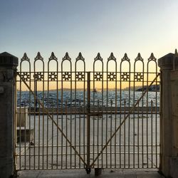 Silhouette metal structure in sea against clear sky