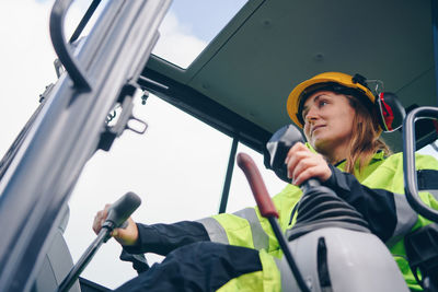Woman driving construction vehicle