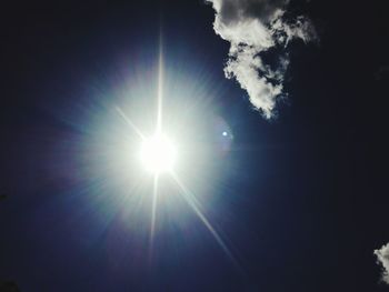 Low angle view of bright sun in sky