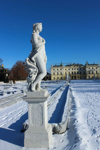 Low angle view of statue against clear blue sky