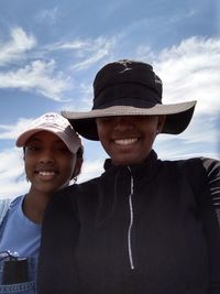 Portrait of smiling man wearing hat against sky