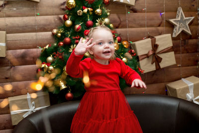 Little girl has fun and rejoices in the upcoming christmas 2023.