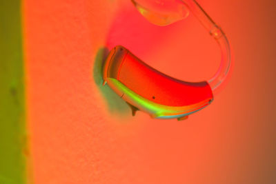 Close-up of multi colored electric lamp against wall