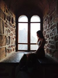 Woman looking through window