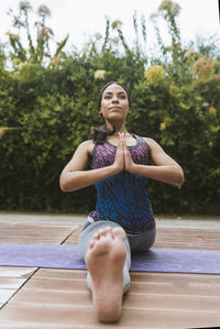 Women making yoga on the park