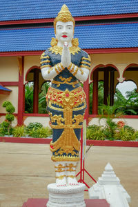 Statue of buddha against building