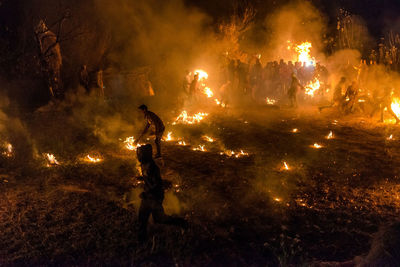 People watching fire crackers at night