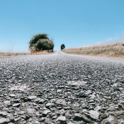 Surface level of road against clear sky