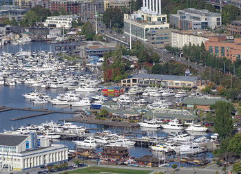 High angle view of cityscape by sea against sky