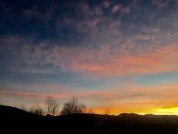 Silhouette landscape against sky during sunset