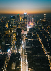 High angle view of illuminated city buildings at night