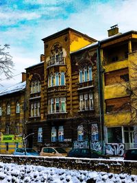 Low angle view of building against sky during winter