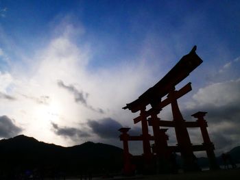 Low angle view of silhouette statue against sky at sunset