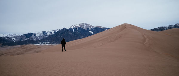 Full length of man on arid landscape against sky