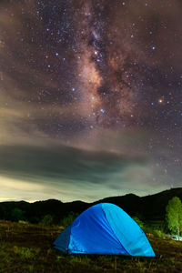 Scenic view of tent against sky at night