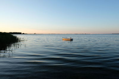 Scenic view of sea against clear sky during sunset