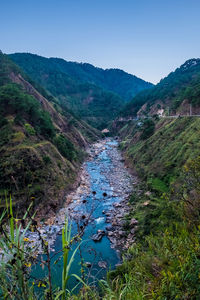 Scenic view of mountains against clear blue sky