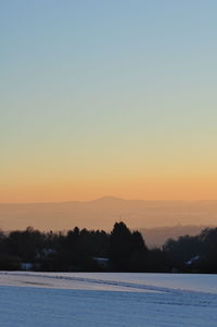 Scenic view of sea against clear sky during sunset