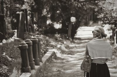 Rear view of man with woman walking outdoors