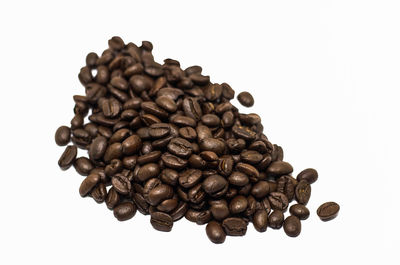 Close-up of coffee beans against white background