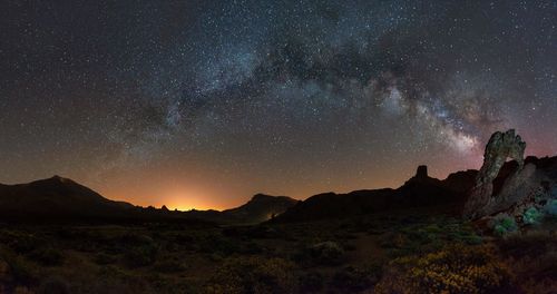 Scenic view of mountains against sky at night