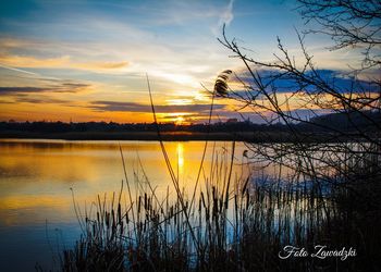 Scenic view of lake against sky during sunset