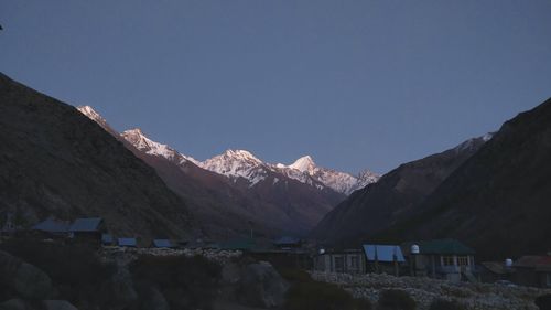 Scenic view of snowcapped mountains against clear blue sky
